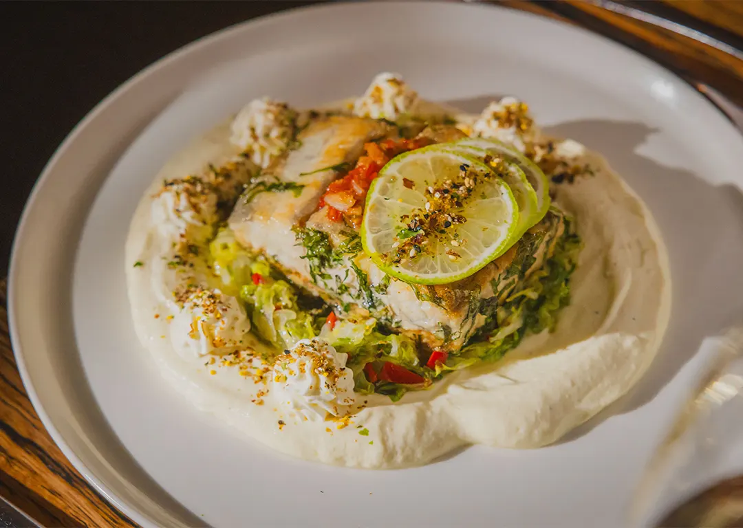 white fish served over a bed of shredded greens
